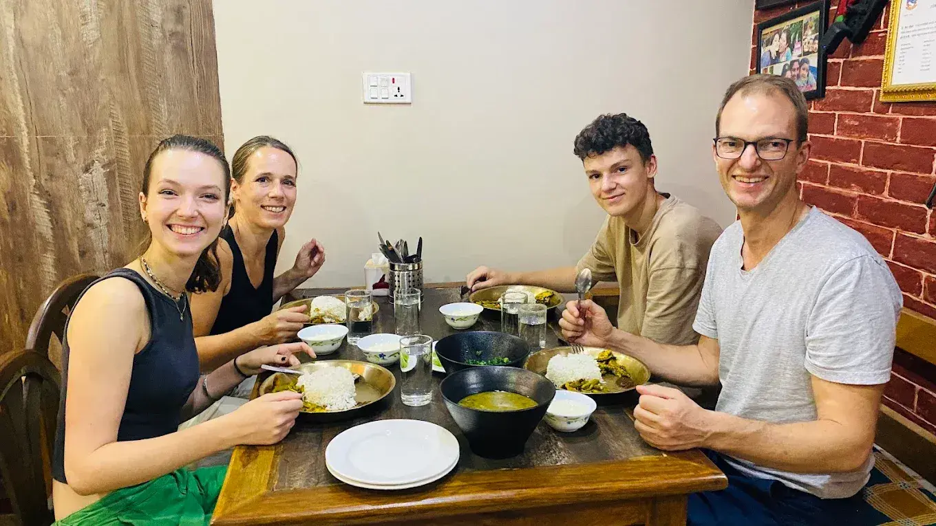 Guests enjoying a home-cooked meal together at Mums Homestay