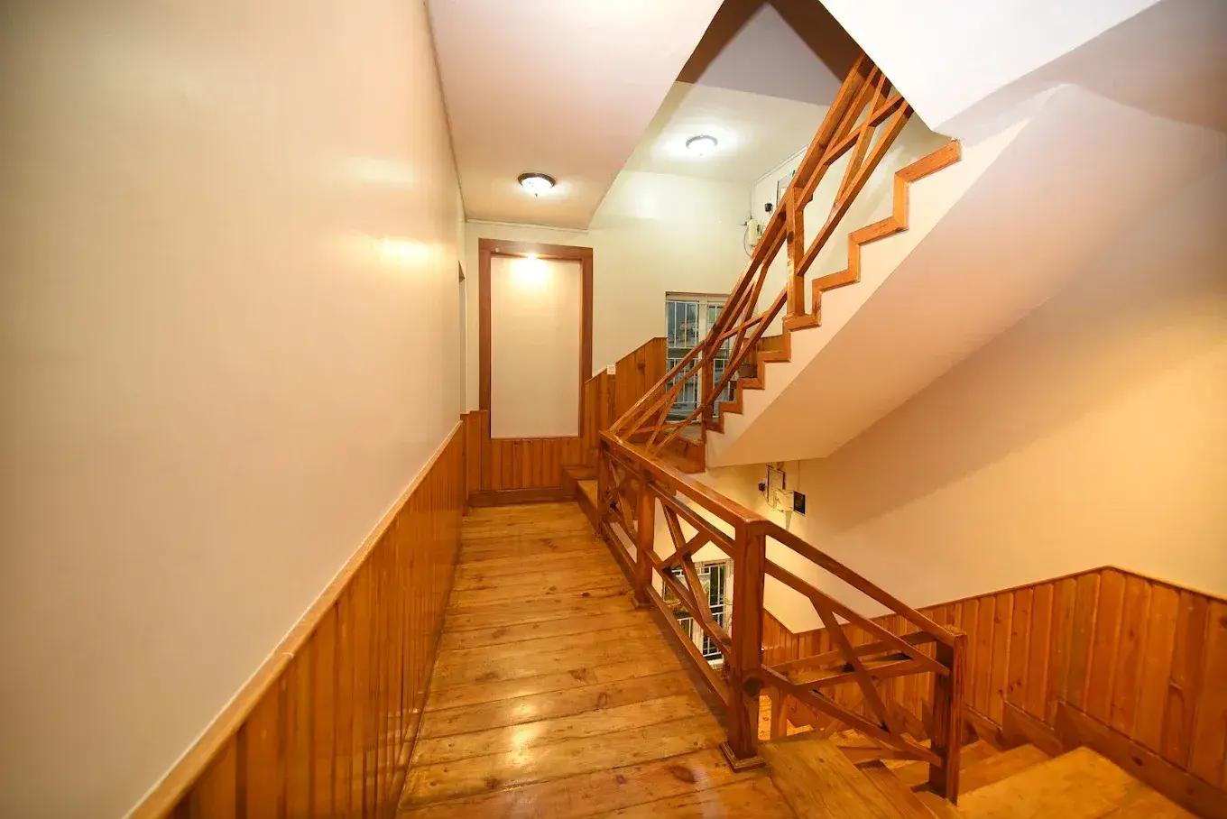 Warm wooden staircase and hallway inside Mums Homestay
